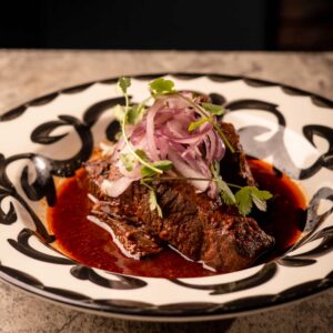 Mariposas Birria: braised beef, lime onions, cilantro, rice, beans, tortillas.