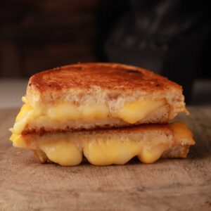 Mariposas kids grilled cheese with melted white cheddar and American cheese between golden toasted sourdough slices.
