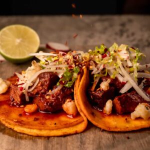 Mariposas Pozole: marinated pork, citrus slaw, Chile aceite, fried hominy.
