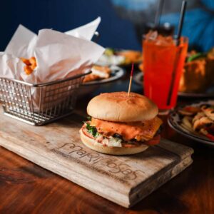 Mariposas Classic Cheeseburger with cheese, lettuce, tomato, onion, pickles, and secret sauce, served with fries.